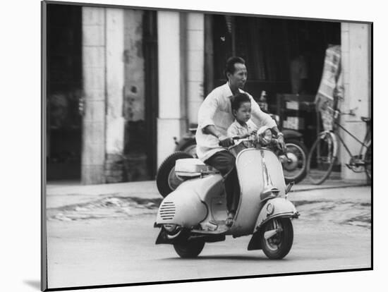 Man with His Son on Scooter-John Dominis-Mounted Photographic Print