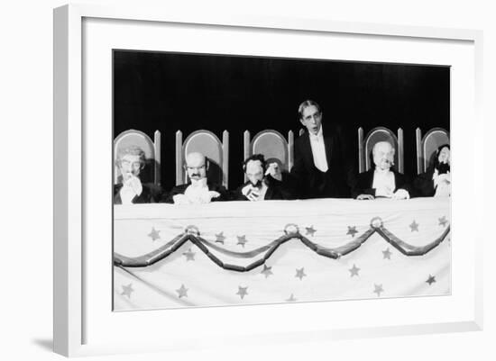 Man with Row of Seated Puppets-null-Framed Photo