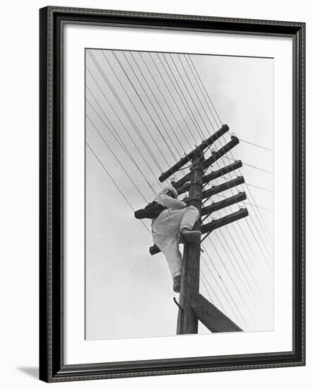 Man Working to Restore the Communication Lines after a Bombing Raid-Carl Mydans-Framed Premium Photographic Print