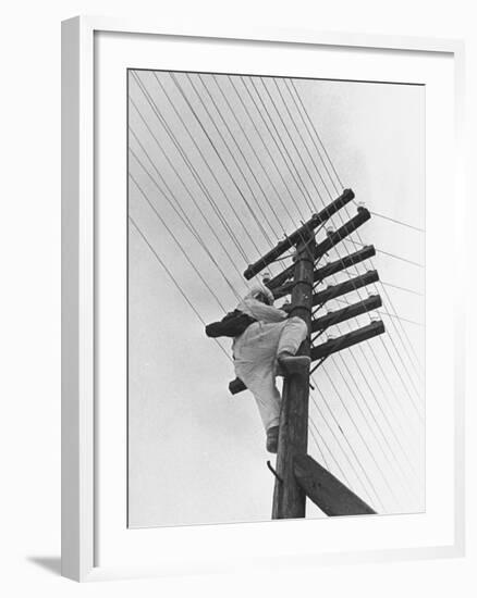 Man Working to Restore the Communication Lines after a Bombing Raid-Carl Mydans-Framed Premium Photographic Print