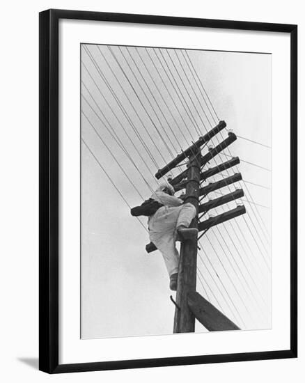 Man Working to Restore the Communication Lines after a Bombing Raid-Carl Mydans-Framed Premium Photographic Print