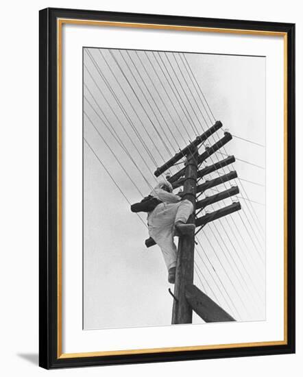 Man Working to Restore the Communication Lines after a Bombing Raid-Carl Mydans-Framed Premium Photographic Print