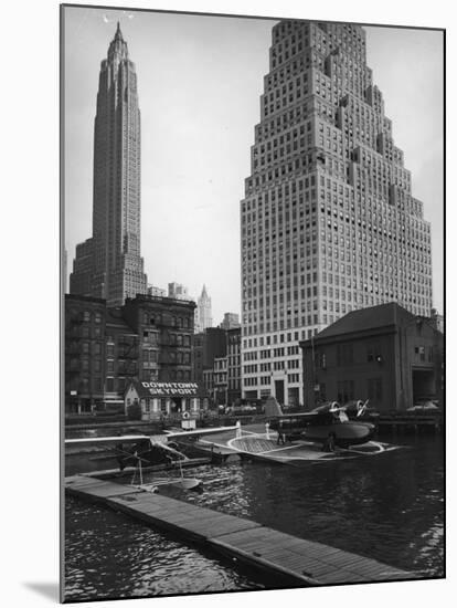 Manhattan's East River Downtown Skyport with Grumman and Fairchild Amphibious Planes-Margaret Bourke-White-Mounted Premium Photographic Print