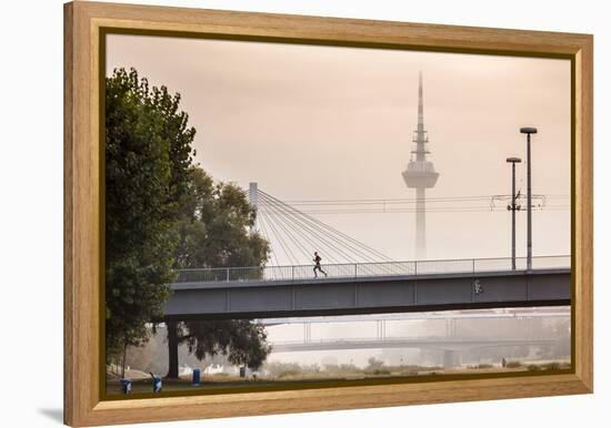 Mannheim, Baden-Württemberg, GER: Male Running Over Bridge Crossing River Neckar On Foggy Morning-Axel Brunst-Framed Premier Image Canvas