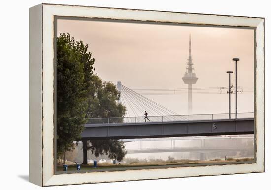 Mannheim, Baden-Württemberg, GER: Male Running Over Bridge Crossing River Neckar On Foggy Morning-Axel Brunst-Framed Premier Image Canvas