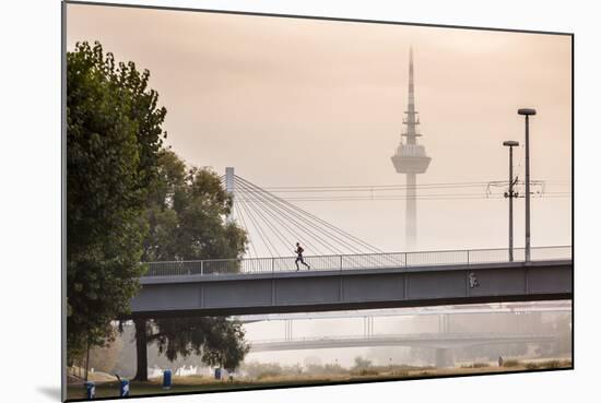 Mannheim, Baden-Württemberg, GER: Male Running Over Bridge Crossing River Neckar On Foggy Morning-Axel Brunst-Mounted Photographic Print