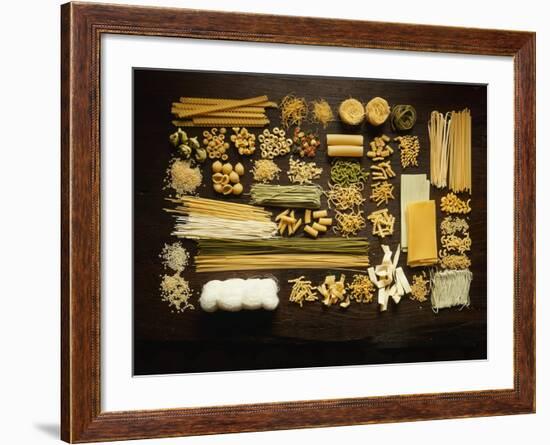 Many Different Types of Pasta on Dark Wooden Background-Walter Cimbal-Framed Photographic Print