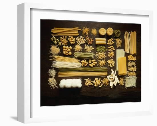 Many Different Types of Pasta on Dark Wooden Background-Walter Cimbal-Framed Photographic Print