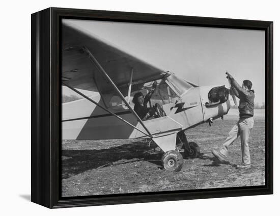 Marie Goerke Sitting in the Plane While the Instructor Kenny Garofalo Stops the Propellor-Bernard Hoffman-Framed Premier Image Canvas