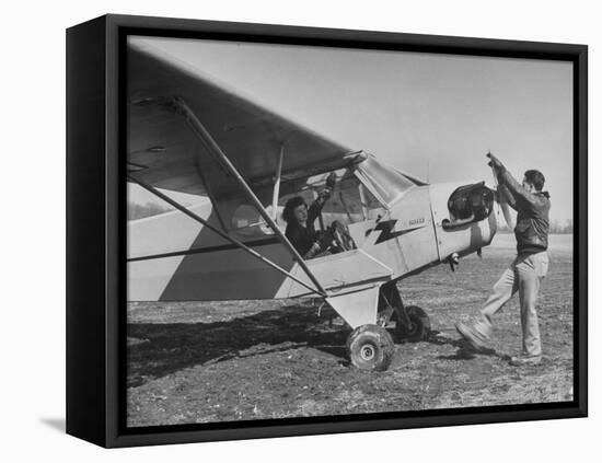 Marie Goerke Sitting in the Plane While the Instructor Kenny Garofalo Stops the Propellor-Bernard Hoffman-Framed Premier Image Canvas