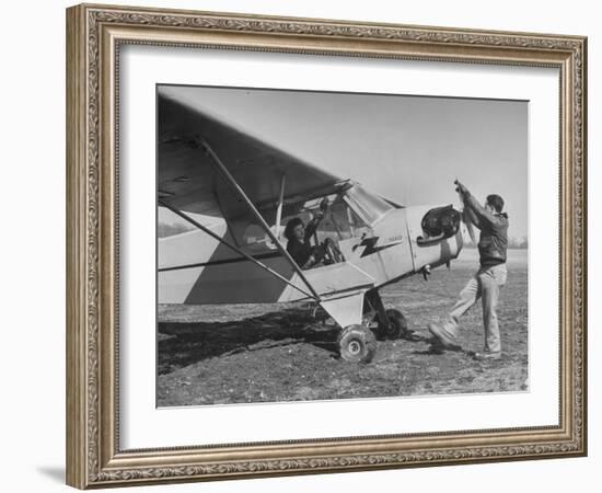 Marie Goerke Sitting in the Plane While the Instructor Kenny Garofalo Stops the Propellor-Bernard Hoffman-Framed Photographic Print