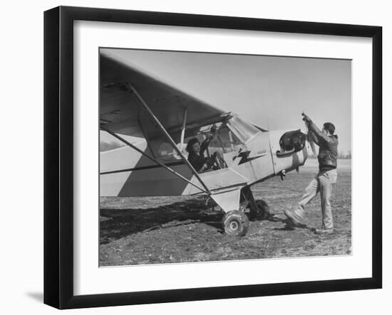 Marie Goerke Sitting in the Plane While the Instructor Kenny Garofalo Stops the Propellor-Bernard Hoffman-Framed Photographic Print