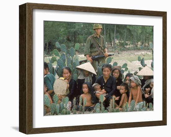 Marine Guarding Mostly Old People and Children Who Are Resting on Their Way to a Refugee Collection-Paul Schutzer-Framed Photographic Print