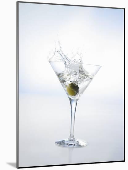 Martini with Green Olive (Splash)-Klaus Arras-Mounted Photographic Print