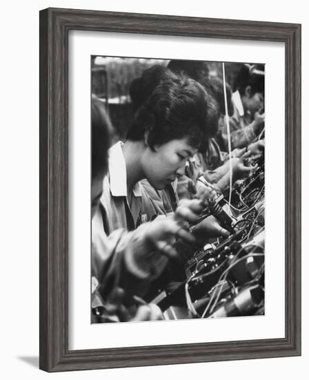 Matsushita Electronics Corp. Women Employees Working in a Factory-Bill Ray-Framed Photographic Print
