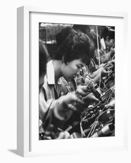 Matsushita Electronics Corp. Women Employees Working in a Factory-Bill Ray-Framed Photographic Print