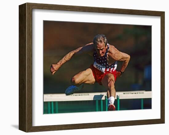 Mature Athlete Competes in Hurdles Race, Atlanta, Georgia, USA-Paul Sutton-Framed Photographic Print