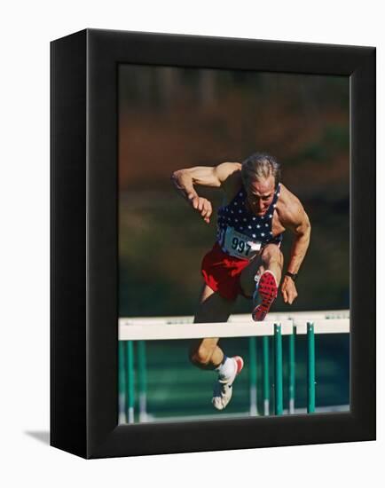 Mature Athlete Competing in Hurdles Race, Atlanta, Georgia, USA-Paul Sutton-Framed Premier Image Canvas