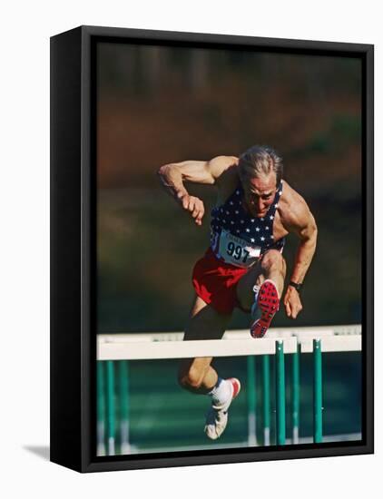 Mature Athlete Competing in Hurdles Race, Atlanta, Georgia, USA-Paul Sutton-Framed Premier Image Canvas