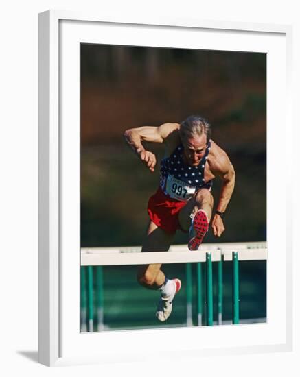 Mature Athlete Competing in Hurdles Race, Atlanta, Georgia, USA-Paul Sutton-Framed Photographic Print