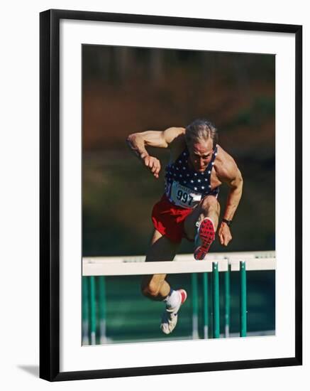 Mature Athlete Competing in Hurdles Race, Atlanta, Georgia, USA-Paul Sutton-Framed Photographic Print