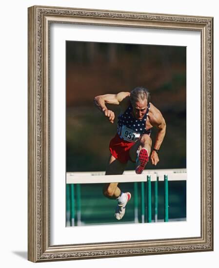 Mature Athlete Competing in Hurdles Race, Atlanta, Georgia, USA-Paul Sutton-Framed Photographic Print