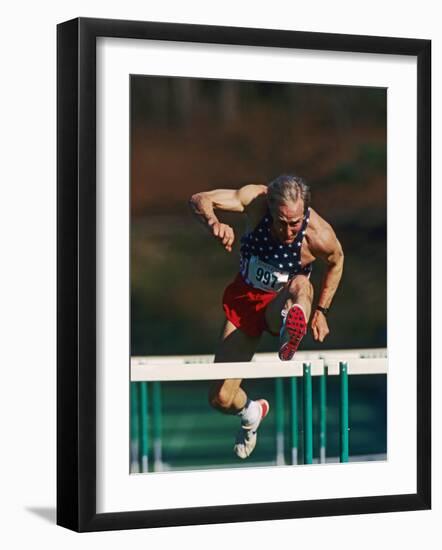 Mature Athlete Competing in Hurdles Race, Atlanta, Georgia, USA-Paul Sutton-Framed Photographic Print