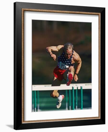 Mature Athlete Competing in Hurdles Race, Atlanta, Georgia, USA-Paul Sutton-Framed Photographic Print