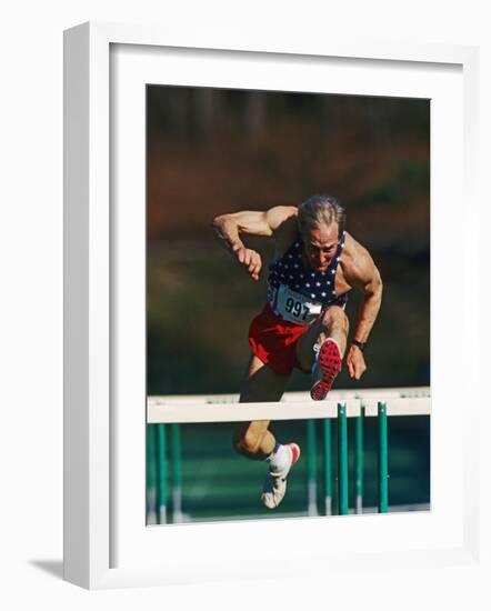 Mature Athlete Competing in Hurdles Race, Atlanta, Georgia, USA-Paul Sutton-Framed Photographic Print