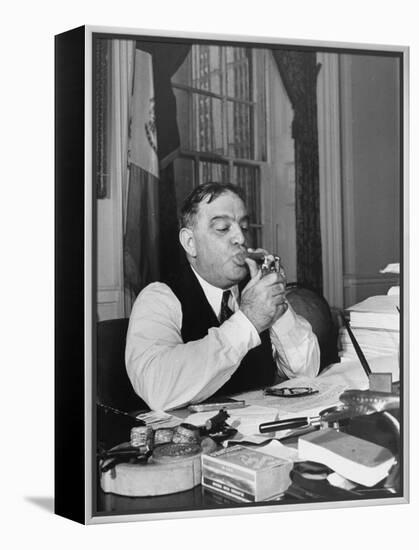 Mayor Fiorello LaGuardia Using Lighter to Light His Cigar While Sitting at His Desk in His Office-William C^ Shrout-Framed Premier Image Canvas