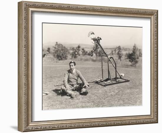 Mechanical Golfer About to Hit Golf Ball Off Man's Head-null-Framed Photo