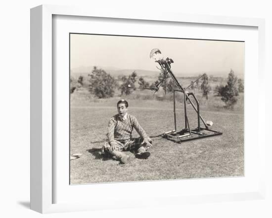 Mechanical Golfer About to Hit Golf Ball Off Man's Head-null-Framed Photo