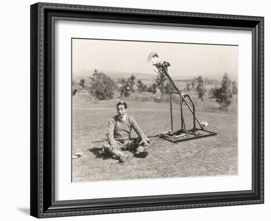 Mechanical Golfer About to Hit Golf Ball Off Man's Head-null-Framed Photo