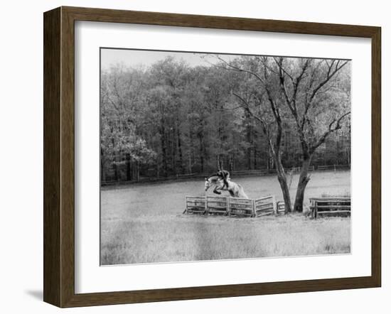 Member of the Us Equestrian Team Jumping the Hurdles in the Fields During the Pre Olympic Practices-Mark Kauffman-Framed Photographic Print