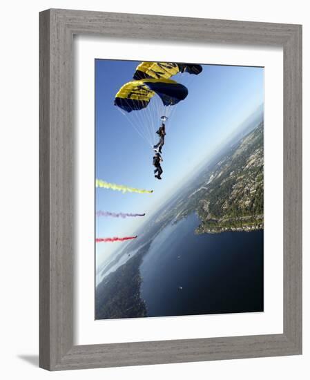 Members of US Navy Parachute Team, the Leap Frogs, Perform Bi-Plane with Parachutes Above Seattle-null-Framed Photographic Print