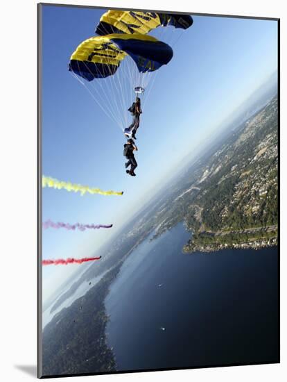 Members of US Navy Parachute Team, the Leap Frogs, Perform Bi-Plane with Parachutes Above Seattle-null-Mounted Photographic Print