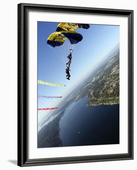 Members of US Navy Parachute Team, the Leap Frogs, Perform Bi-Plane with Parachutes Above Seattle-null-Framed Photographic Print