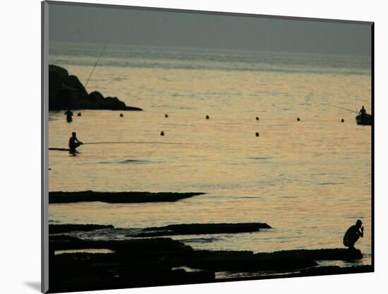 Men are Silhouetted Against the Sea as They Fish and Relax on the Beirut Coastline, August 24, 2006-Matt Dunham-Mounted Photographic Print