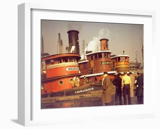 Men at pier looking at 3 Tugboats, One Named "Courageous" with Crewmen on Deck-Andreas Feininger-Framed Photographic Print