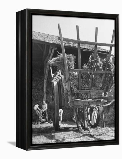 Men Constructing a Wheat Wreath Behind a Wheat Filled Wagon During the Harvest Season-Hans Wild-Framed Premier Image Canvas