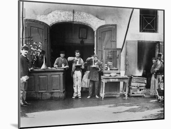 Men Eating Long Spaghetti at a Street Food Shop in Naples, Italy, Ca. 1900-null-Mounted Photo