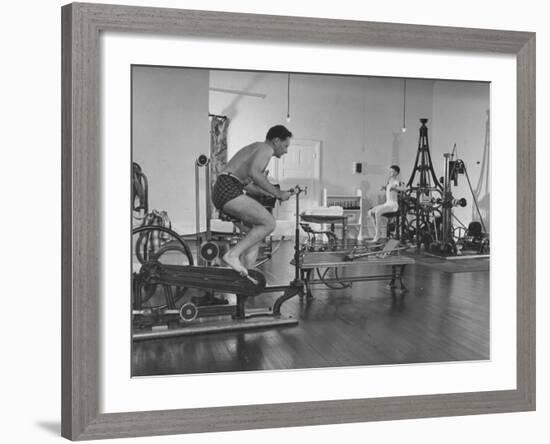 Men Exercising in Gymnasium at Homestead Hotel-John Phillips-Framed Premium Photographic Print