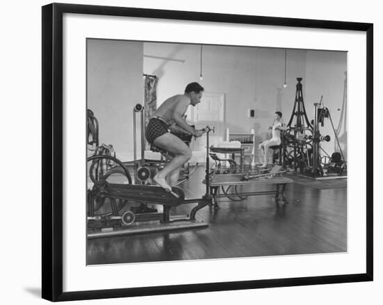 Men Exercising in Gymnasium at Homestead Hotel-John Phillips-Framed Premium Photographic Print