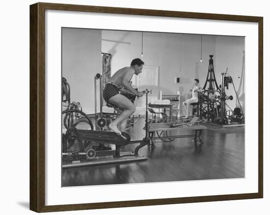 Men Exercising in Gymnasium at Homestead Hotel-John Phillips-Framed Premium Photographic Print