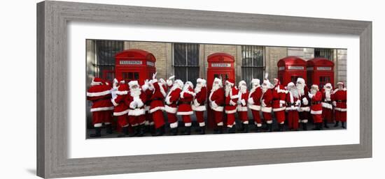 Men from the London Santa School, Dressed in Christmas Outfits, Pose by Telephone Boxes in London-null-Framed Photographic Print