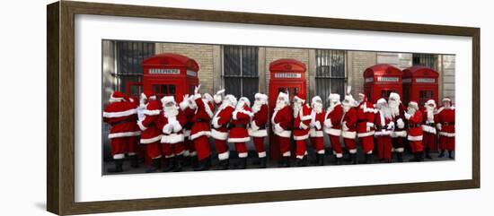 Men from the London Santa School, Dressed in Christmas Outfits, Pose by Telephone Boxes in London-null-Framed Photographic Print