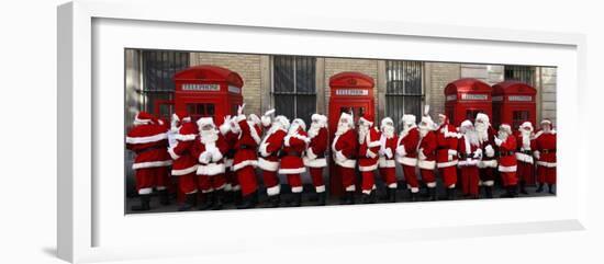 Men from the London Santa School, Dressed in Christmas Outfits, Pose by Telephone Boxes in London--Framed Photographic Print