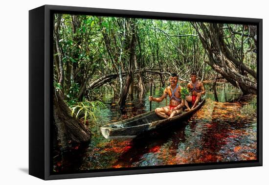 Men from the Yanomami tribe in a canoe, southern Venezuela-Michael Runkel-Framed Premier Image Canvas