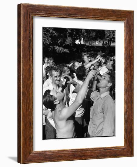 Men Having a Beer Drinking Contest at the Company Picnic-Allan Grant-Framed Photographic Print