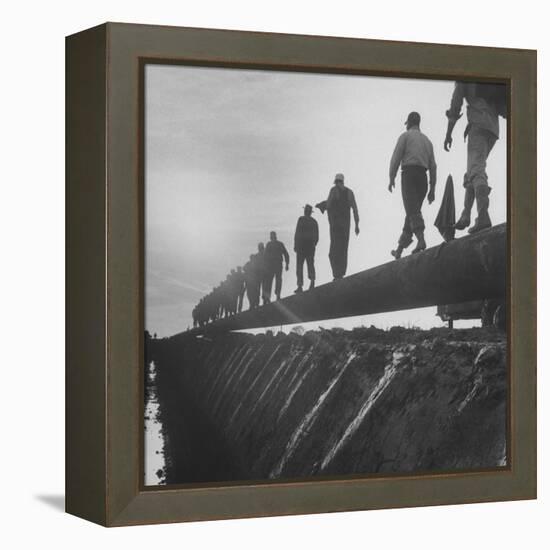 Men Laying Pipeline-null-Framed Premier Image Canvas